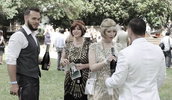 Guests conversating over cocktails at The Great Gatsby lawn party