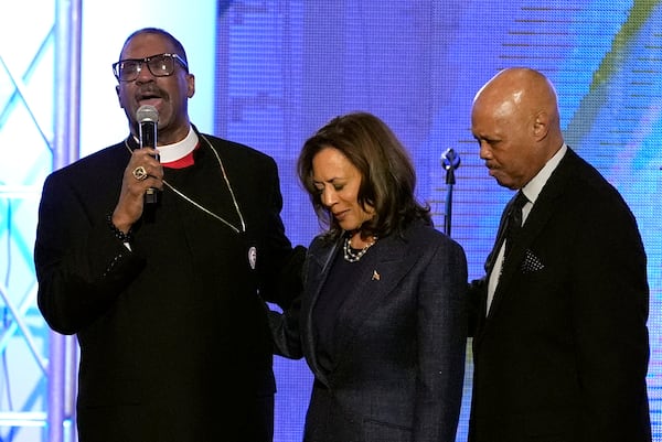 Bishop John Drew Sheard, from left, leads a congregation in a prayer over Democratic presidential nominee Vice President Kamala Harris, center right, during a church service at Greater Emmanuel Institutional Church of God in Christ, Sunday, Nov. 3, 2024, in Detroit. (AP Photo/Jacquelyn Martin)