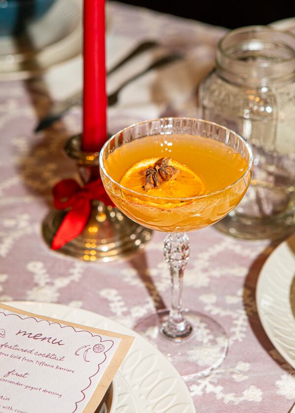 Tiffanie Barriere developed the Spiced Citrus Gold cocktail for reporter Olivia Wakim's Galentine's Day supper club. The cocktail is warm and citrusy with layers of spice and a touch of sweetness. (Aaliyah Man for The Atlanta Journal-Constitution)