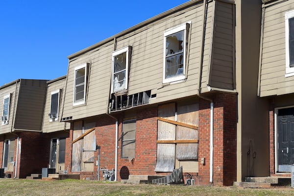 Broken windows and missing siding are a common site at the Forest Cove apartment complex seen Tuesday, Feb. 1, 2022. (Daniel Varnado/For the Atlanta Journal-Constitution)