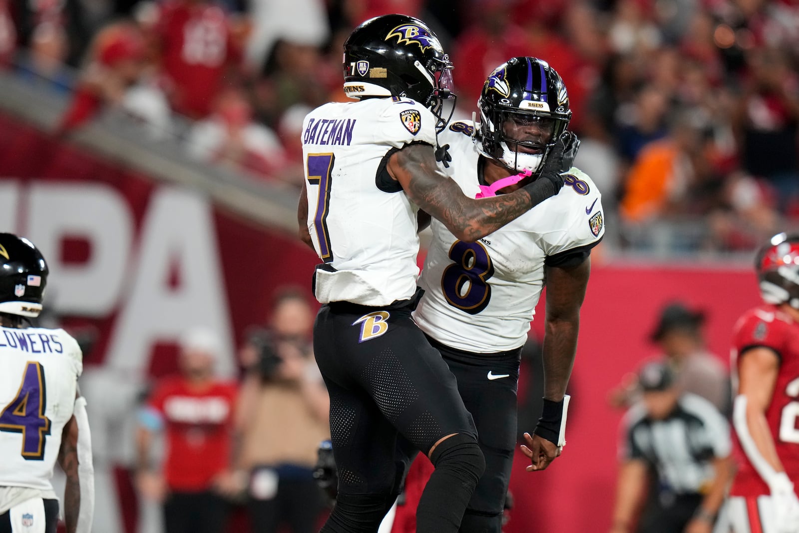 Baltimore Ravens wide receiver Rashod Bateman (7) and quarterback Lamar Jackson (8) celebrate after Bateman's touchdown during the second half of an NFL football game, Monday, Oct. 21, 2024, in Tampa, Fla. (AP Photo/Chris O'Meara)