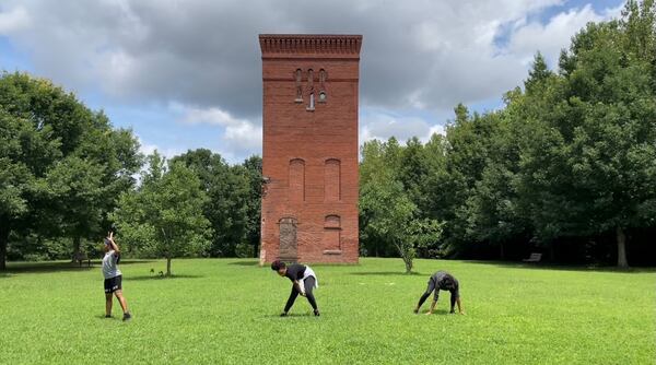 Dancers Morgan Hawkins, Christiana McLeod Horn and Aquilah Ohemeng, perform an early version of the dance "Idle Crimes and Heavy Work" at Whittier Mill Village Park.