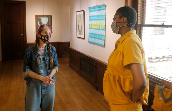 Artist Jerushia Graham speaks with art teacher Brook Hewitt about her new exhibit, “Freedom Isn’t Free,” at Callanwolde Fine Arts Center in Atlanta on Tuesday, July 20, 2021. The show runs from July 15 to Sept. 2. (Christine Tannous / christine.tannous@ajc.com)