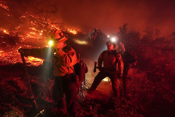 Firefighters battle the Lilac Fire in Bonsall, Calif., Tuesday, Jan. 21, 2025. (AP Photo/Jae C. Hong)