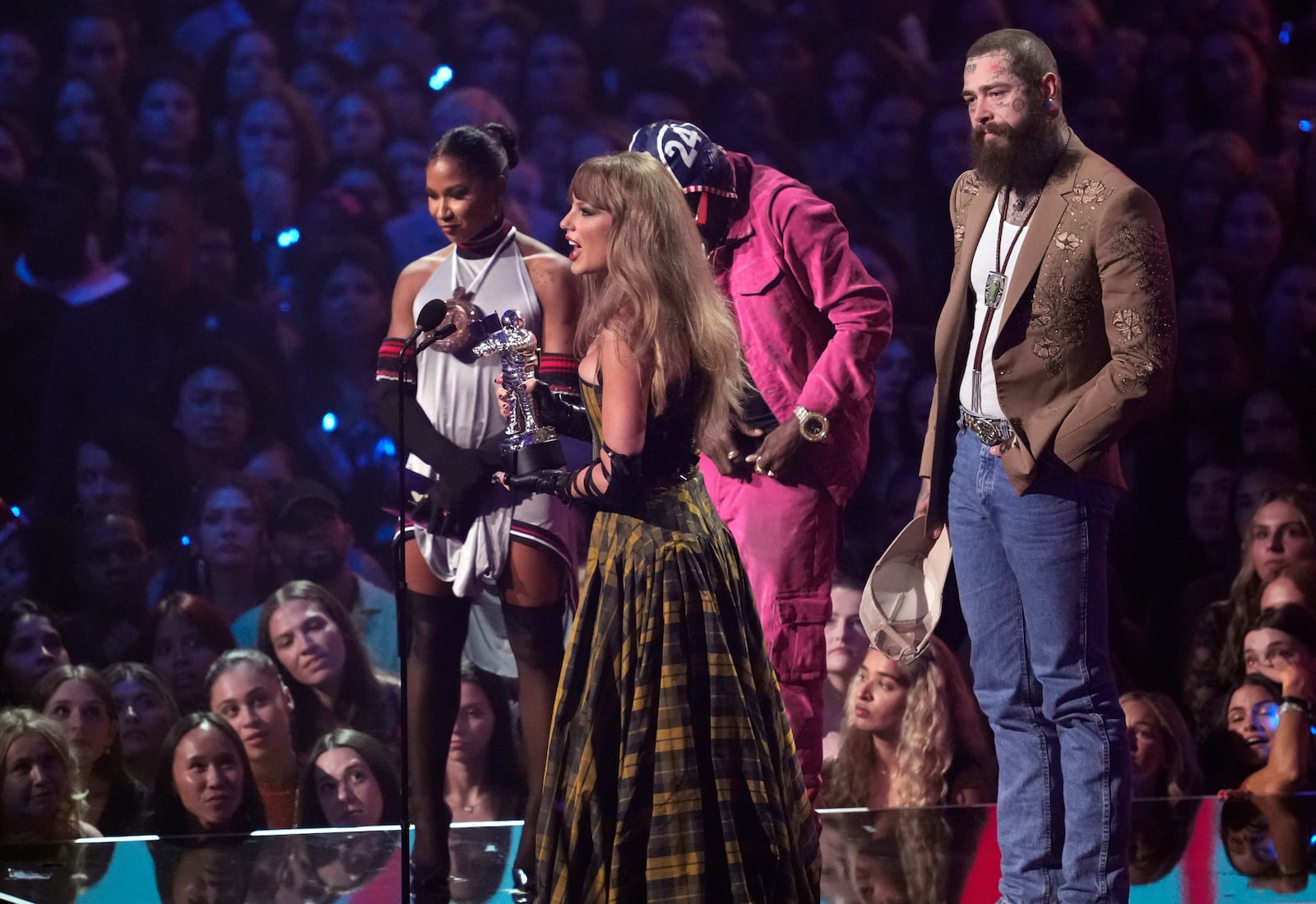 Taylor Swift, center, and Post Malone, far right, accept the award for best collaboration for "Fortnight" during the MTV Video Music Awards on Wednesday, Sept. 11, 2024, at UBS Arena in Elmont, N.Y. (Photo by Charles Sykes/Invision/AP)