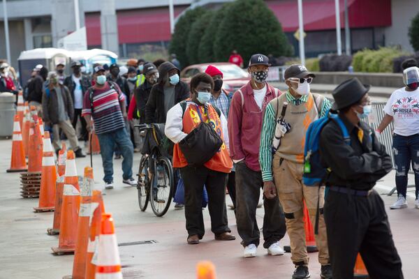 People line up for the annual Hosea Williams Thanksgiving Dinner outside the Georgia World Congress Center on Thursday, Nov. 26, 2020. Because of the COVID-19 pandemic, the 2020 dinner was to-go. This year’s dinner will be a drive-thru affair. (Steve Schaefer for The Atlanta Journal-Constitution)