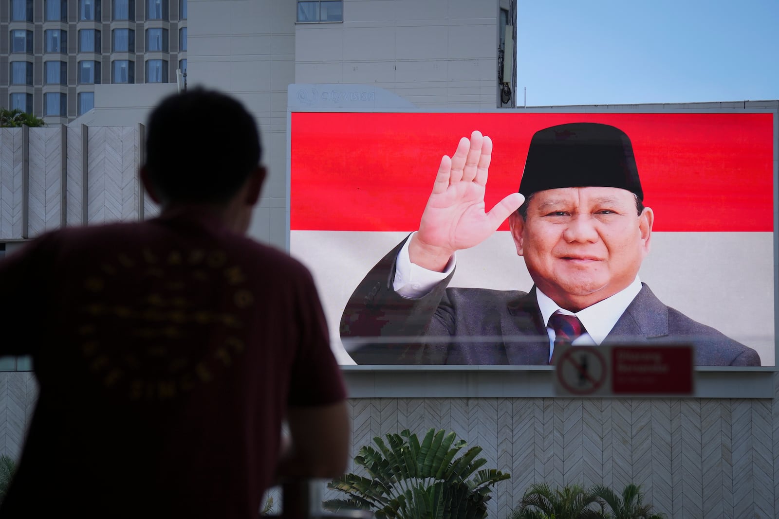 Picture of Newly-inaugurated Indonesian President Prabowo Subianto are seen on a giant screen outside a building in Jakarta, Indonesia, Sunday, Oct. 20, 2024. (AP Photo/Dita Alangkara)