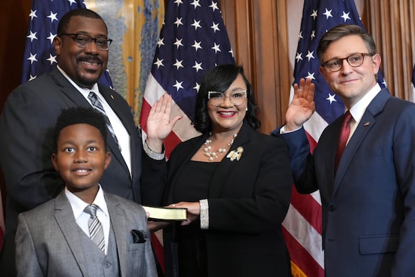 House Speaker Mike Johnson, R-La., (right), poses during a ceremonial swearing-in with Democratic U.S. Rep. Nikema Williams of Atlanta, whose family was in Washington on Friday.