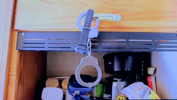 Prosecutors showed jurors this photograph of handcuffs that investigators found inside Christopher Scott Palmer's motor home during their investigation of 9-month-old Cody Palmer's death in early 2022. (Joe Kovac Jr. / AJC)