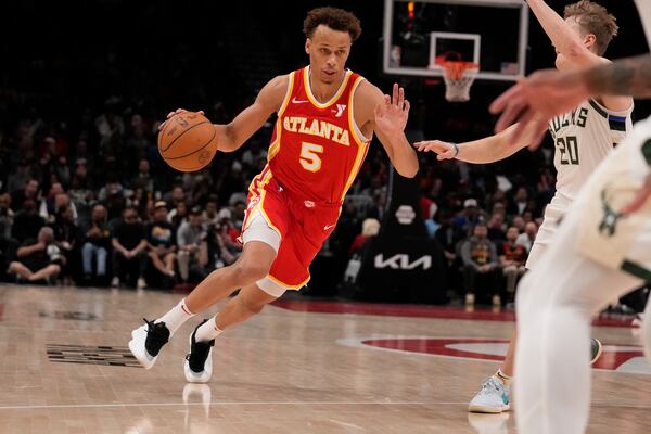 Atlanta Hawks guard Dyson Daniels (5) dribbles the ball in the first half of an NBA basketball game against the Milwaukee Bucks, Tuesday, March 4, 2025, in Atlanta. (AP Photo/Brynn Anderson)