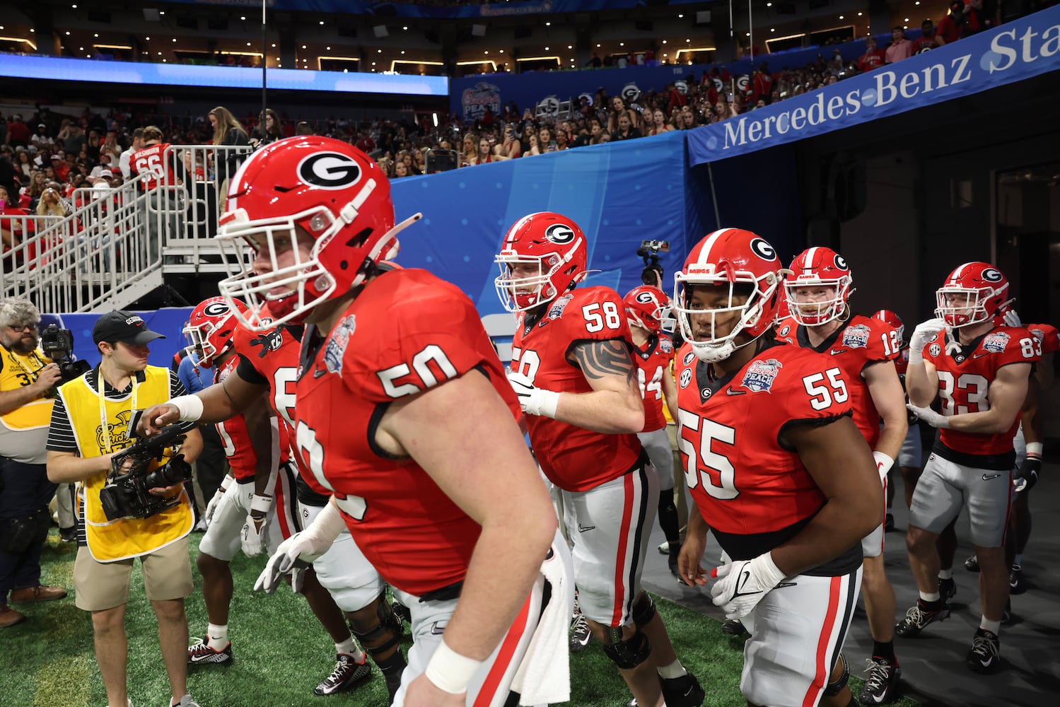 Georgia Bulldogs offensive lineman Warren Ericson (50), offensive lineman Austin Blaske (58) and Georgia Bulldogs offensive lineman Jared Wilson (55) take the field for warmups before the College Football Playoff Semifinal between the Georgia Bulldogs and the Ohio State Buckeyes at the Chick-fil-A Peach Bowl In Atlanta on Saturday, Dec. 31, 2022. (Jason Getz / Jason.Getz@ajc.com)