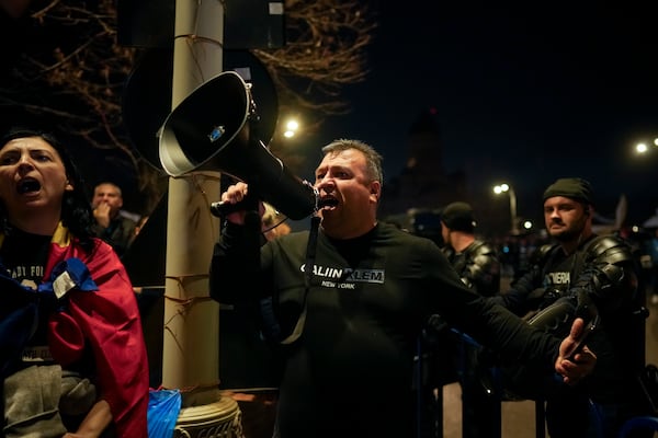 A supporter of Calin Georgescu screams during a protest after Romania's Constitutional Court upholded a ban on his candidacy in the presidential election rerun, in Bucharest, Romania, Tuesday, March 11, 2025. (AP Photo/Vadim Ghirda)