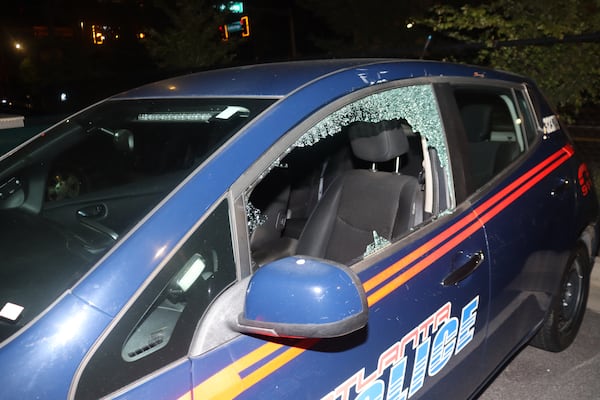 An hour before motorcycles were set on fire at an Atlanta Police Department precinct, officials allege the same group was involved in the smashing of windows at a precinct on Memorial Drive.