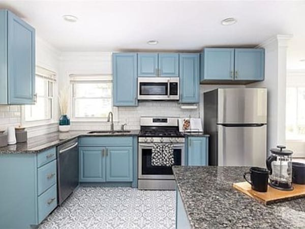 Blue cabinetry is among the features of the recently updated kitchen.