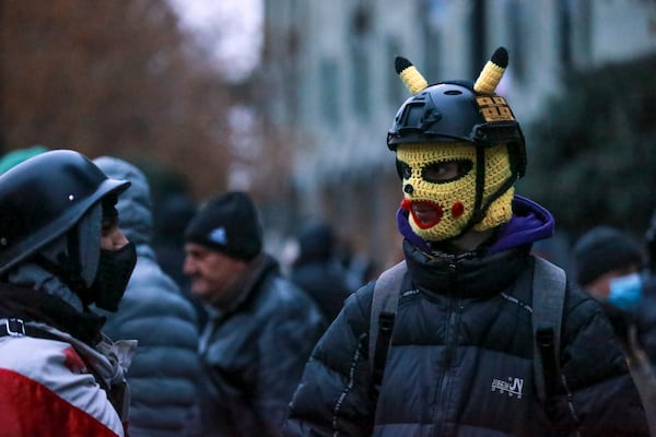 Protesters gather in a street during a rally to demand new parliamentary elections in the country, near the Parliament's building in Tbilisi, Georgia, on Monday, Nov. 25, 2024. (AP Photo/Zurab Tsertsvadze)