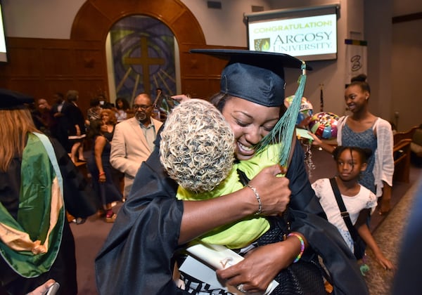 June 8, 2019 Atlanta - Cheryl Walker hugs her friend Camille Jackson after she received her degree during 2019 Argosy University Atlanta Commencement at Church of Christ at Bouldercrest in Atlanta on Saturday, June 8, 2019.  HYOSUB SHIN / HSHIN@AJC.COM