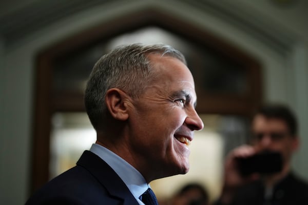 Liberal Leader Mark Carney talks to media as he leaves a caucus meeting in Ottawa, Monday, March 10, 2025. (Sean Kilpatrick/The Canadian Press via AP)