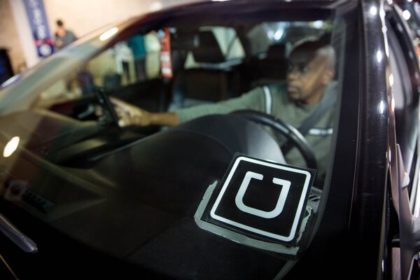 Uber driver Peter Njiru waits for his passenger at the designated rideshare area at Hartsfield-Jackson Atlanta International Airport. BRANDEN CAMP/SPECIAL