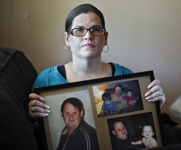 Jennifer Doxakis holds photos of her brother, 39-year-old Jason Brady, who she believes died because of poor care by EMS officials. 