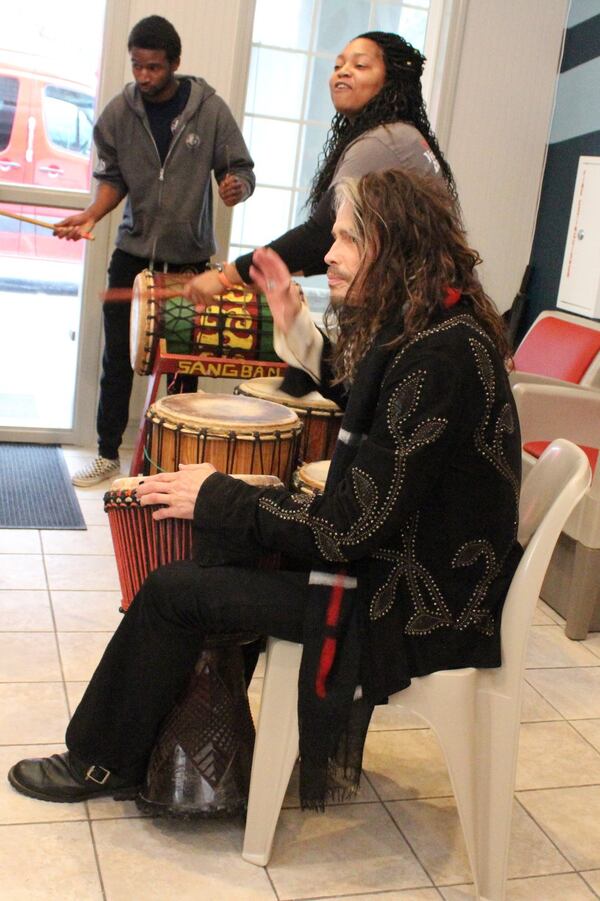  Steven Tyler plays drums with Tatiana Rolles (next to Tyler) and Judah Davis after entering Janie's House on Dec. 6, 2017. Photo: Melissa Ruggieri/AJC