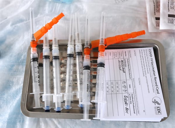 Moderna COVID-19 vaccines sit on a tray as they are prepared to be administered to health care workers at the DeKalb County COVID-19 BrandsMart USA drive-thru testing site on Jan. 7, 2021, in Doraville. (Curtis Compton / The Atlanta Journal-Constitution)