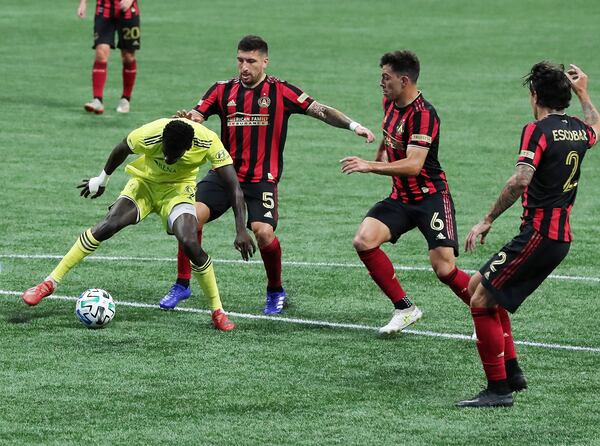 Nashville forward Dominique Badji (from left) finds his path to the net blocked by Atlanta United defenders Eric Remedi, Fernando Meza, and Franco Escobar during the first half Saturday, Aug. 22, 2020 in Atlanta.    (Curtis Compton ccompton@ajc.com)