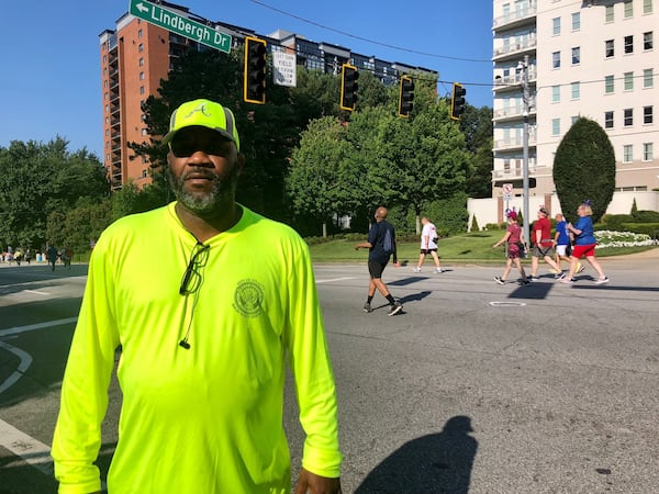 City of Atlanta employee Eugene Edwards at the AJC Peachtree Road Race on July 4, 2021. Edwards parked his garbage truck at the corner of Peachtree Road and Lindbergh Drive as a deterrent against a potential attack on the race. Edwards was at the race both July 3 and 4, as the race was spread out over two days as a COVID-19 precaution. “It’s Fourth of July and the people are happy and they’re enjoying themselves, so we want to protect them,” Edwards said. (AJC photo by Ken Sugiura)