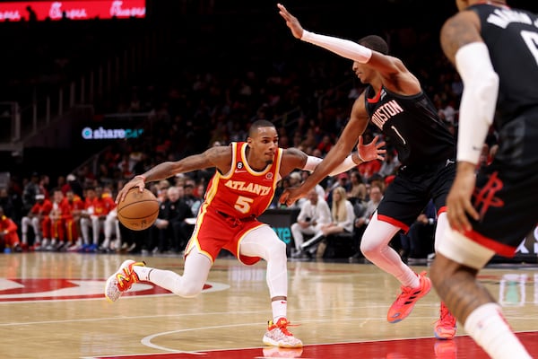 Atlanta Hawks guard Dejounte Murray (5) drives against Houston Rockets forward Jabari Smith Jr. (1) during the third quarter at State Farm Arena, Wednesday, October 19, 2022, in Atlanta. The Hawks won 117 - 107. This is the Atlanta Hawks’ opener for the 2022-2023 season. (Jason Getz / Jason.Getz@ajc.com)