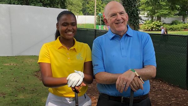 Hailey Fisher, left, shot the ceremonial opening drive at the Tour Championship ahead of the first round, Thursday, Aug. 22, 2019, at East Lake Golf Club in Atlanta. Fisher represented First Tee of Metro Atlanta. Bob Jones IV, the grandson of golf legend Bobby Jones, shot the ceremonial opening shot.