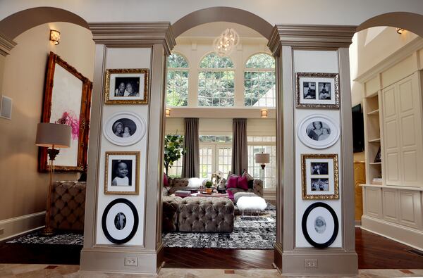 Family photos hang at the entrance to the family room.