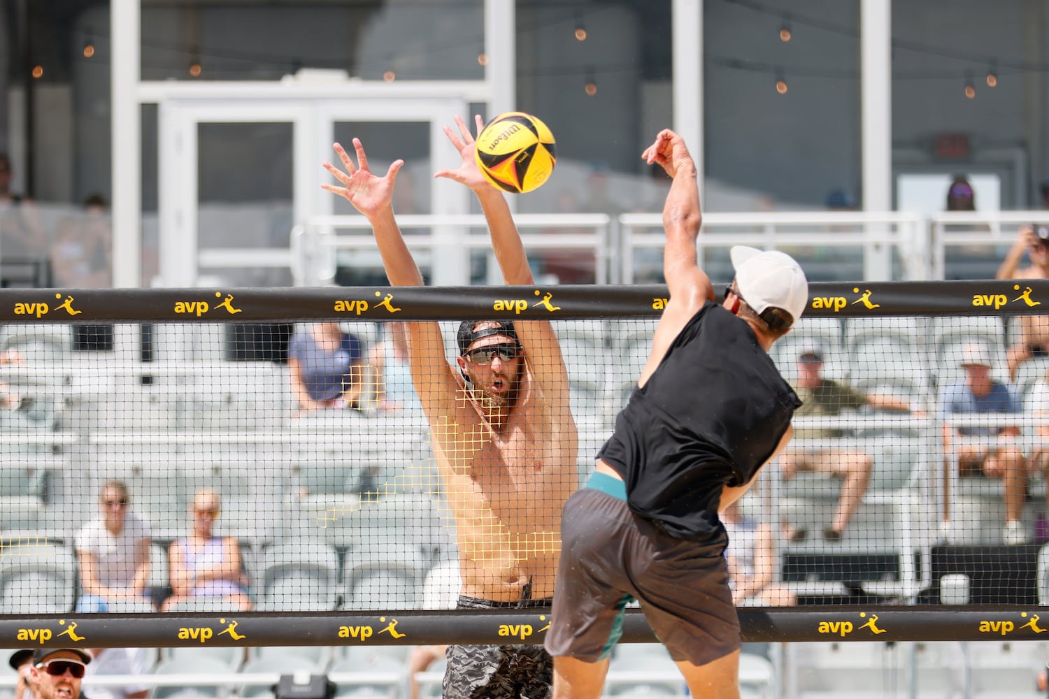 Theo Brunner blocks Miles Partain's spike during the second set of the AVP Gold Series Atlanta Open men's championship match Sunday at Atlantic Station. (Miguel Martinez / miguel.martinezjimenez@ajc.com)