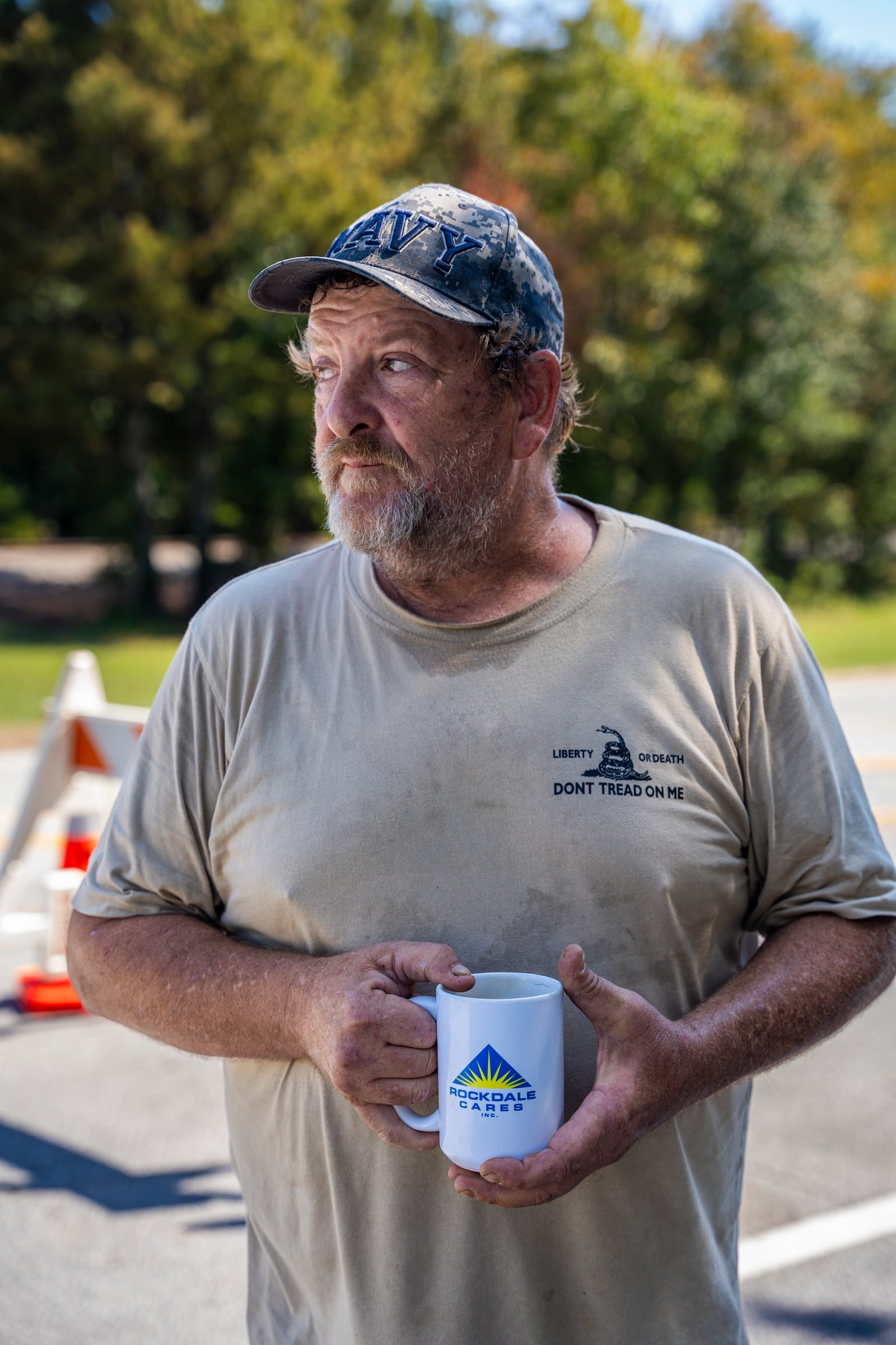 James Donegan stands in front of a barricade blocking cars from entering the street where he lives, recounting the past two weeks within the immediate evacuation zone following the BioLab incident in Conyers. The security guard explained on Oct. 8 that only people with respirators or a doctor’s note are allowed past the barricade, yet locals continue to reside beyond it. Donegan also shared that his home garden has turned yellow and is no longer salvageable. Olivia Bowdoin for the AJC.