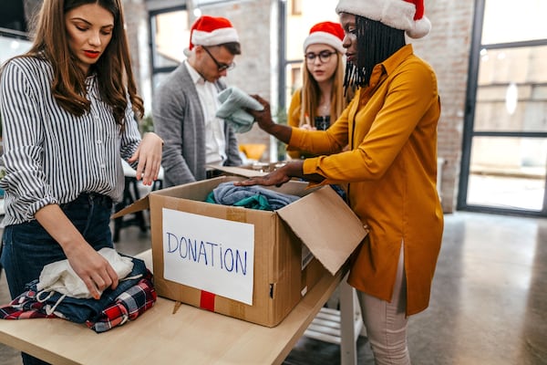 These Santa's helpers, who found their volunteering opportunity through Hands on Atlanta, sort through donations to distribute to people in need. (Courtesy of Hands On Atlanta)