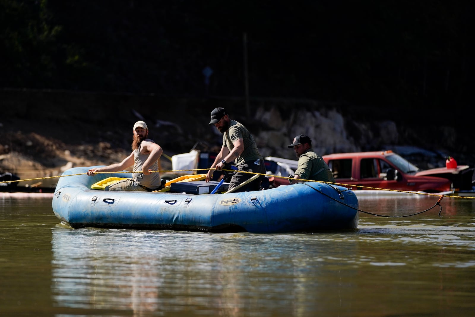 Civilian volunteers using an inflatable raft deliver supplies to residents in the aftermath of Hurricane Helene, Tuesday, Oct. 8, 2024, in Burnsville, N.C. (AP Photo/Erik Verduzco)