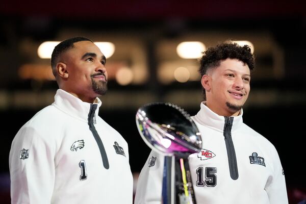 Eagles quarterback Jalen Hurts (left) and Chiefs quarterback Patrick Mahomes pose with the Lombardi Trophy during Super Bowl festivities in New Orleans.