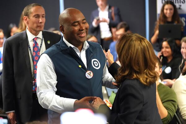 Democratic presidential nominee Vice President Kamala Harris, right, greets DNC Chair Jaime Harrison after phone banking with volunteers at the DNC headquarters on Election Day, Tuesday, Nov. 5, 2024, in Washington. (AP Photo/Jacquelyn Martin)