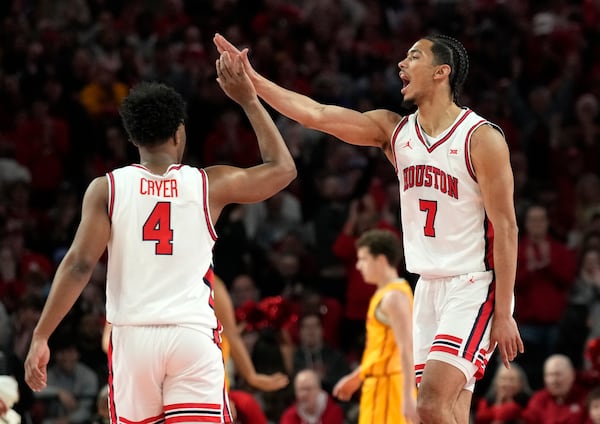 Houston guard Milos Uzan (7) celebrates his 3-pointer with guard L.J. Cryer (4) during the first half of an NCAA college basketball game against Iowa State in Houston, Saturday, Feb. 22, 2025. (AP Photo/Karen Warren)