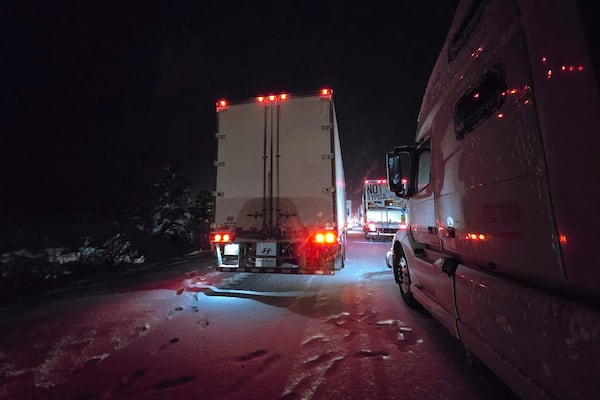 Trucks sit in traffic backed up for more than 15 miles on a westbound stretch of Interstate 40 between Flagstaff and Williams, Ariz., on Friday, March 7, 2025. (AP Photo/Felicia Fonseca)