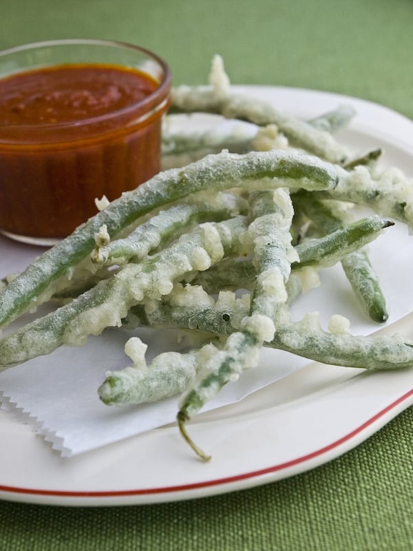 Crispy Green Beans With Salsa Brava, from Kevin Gillespie’s cookbook “Fire in My Belly: Real Cooking,” offers beans with snap and a sauce with kick. His suggested beer pairing: Beacon of the Abyss Bright Lager from Burial Beer. CONTRIBUTED BY ANGIE MOSIER