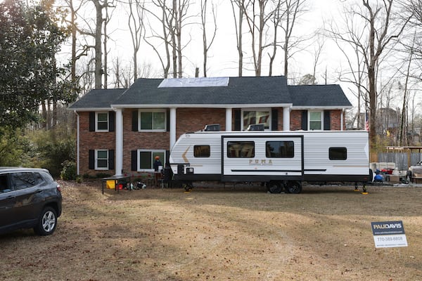 An RV is shown out front of the damaged home of Chris and April Willars after a house fire earlier this month, Thursday, Jan. 30, 2025, in Conyers. The couple were on the property to salvage any items they could. They were also impacted by the BioLab fire and a tornado in the past year. (Jason Getz / AJC)