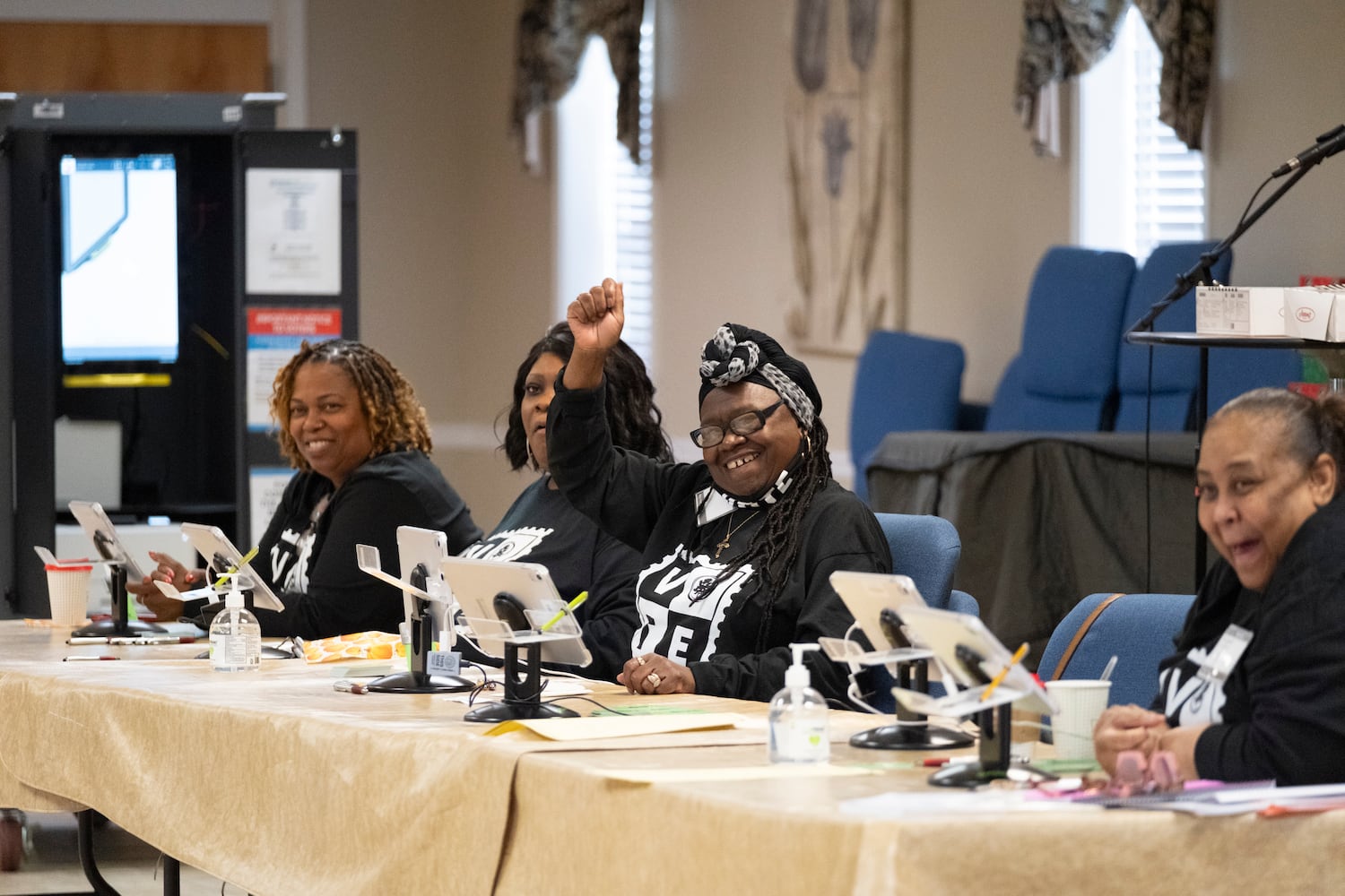 Poll workers cheer on voters at First Baptist Church in Fairburn on Tuesday, Nov. 5, 2024.   Ben Gray for the Atlanta Journal-Constitution