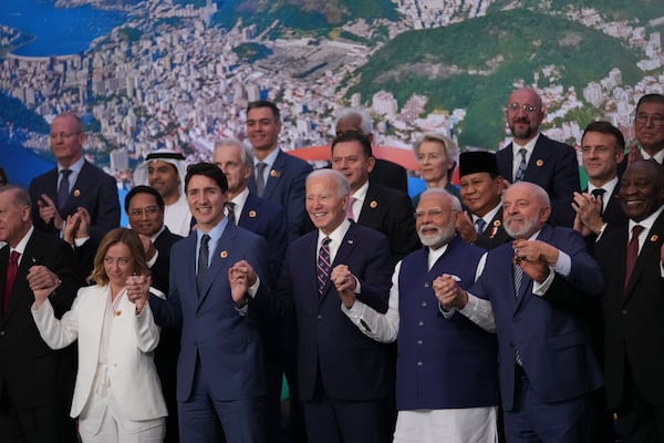 World leaders attending the G20 Summit pose for a group photo in Rio de Janeiro, Tuesday, Nov. 19, 2024. (AP Photo/Silvia Izquierdo)