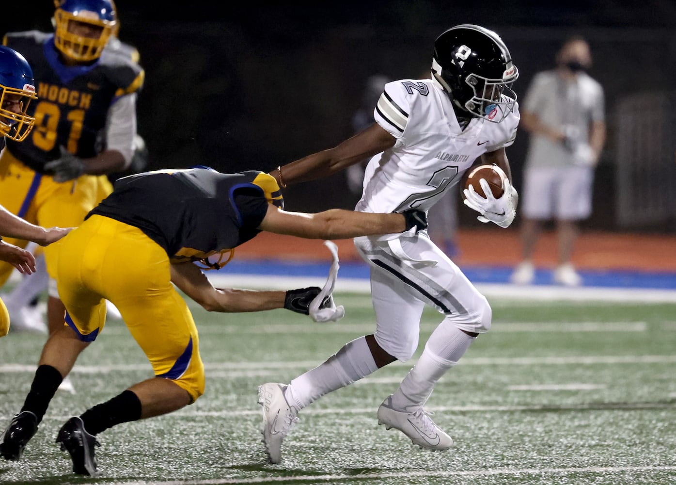 Alpharetta wide receiver Cameron Foster (2) gets by the defense of Chattahoochee's Owen Maling (12) after a catch in the second half at Chattahoochee high school Friday, September 25, 2020 in Johns Creek, Ga.. Alpharetta won 21-7. JASON GETZ FOR THE ATLANTA JOURNAL-CONSTITUTION