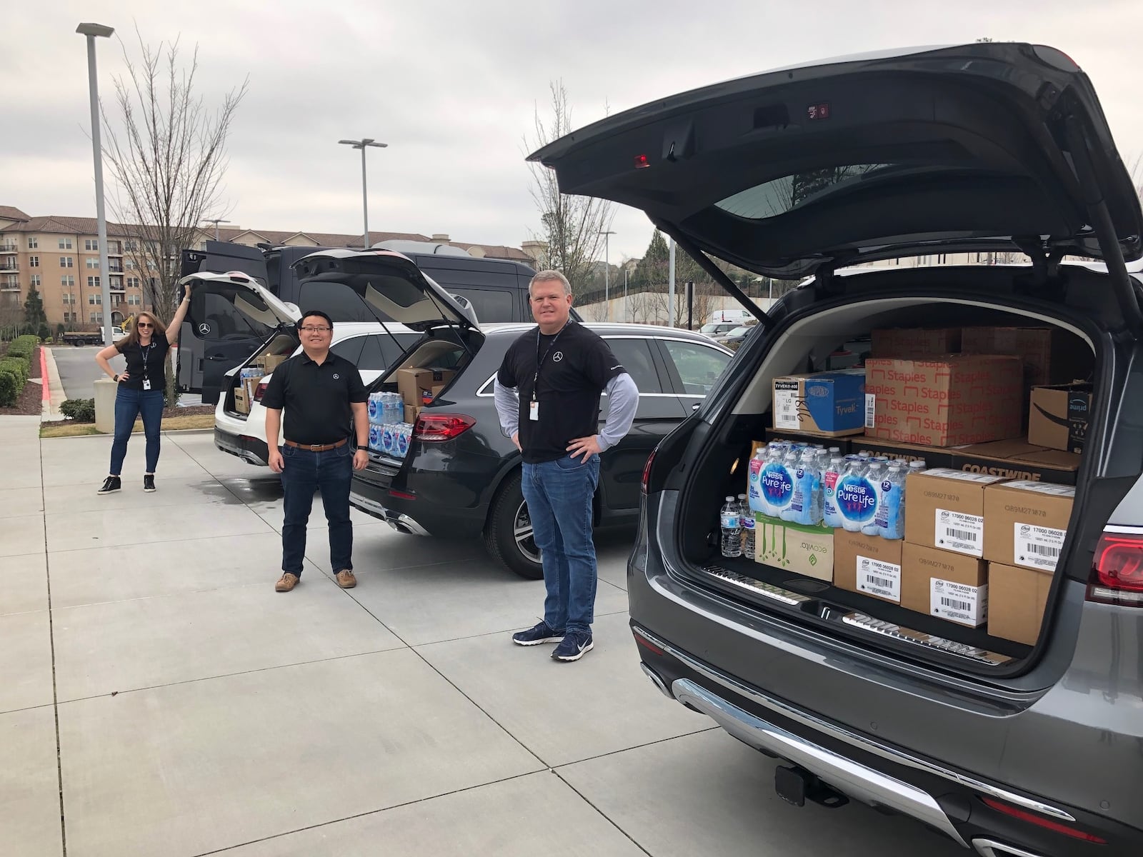 Mercedes-Benz USA employees pack emergency kits for The Salvation Army into vehicles at the company’s headquarters in Sandy Springs. Items were donated by members of the Disaster Action Alliance, a coalition of local corporations and nonprofits created two years ago to offer aid during natural disasters. Courtesy Mercedes Benz-USA