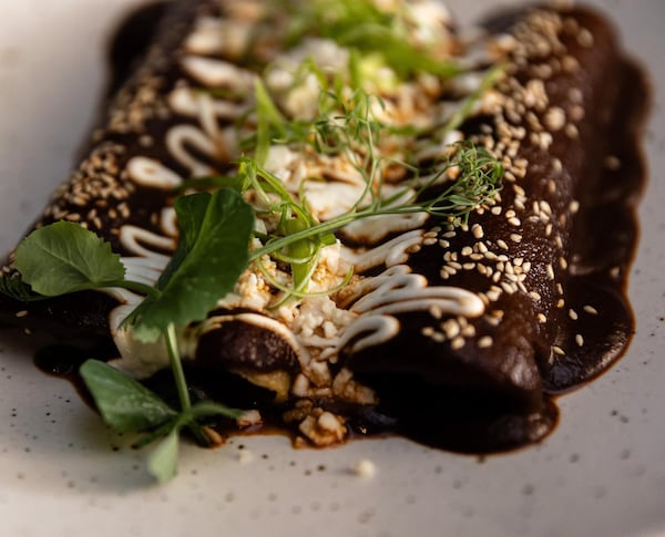 Enmoladas at Pata Negra are enchiladas enveloped in a mole negro sauce. Courtesy of Pata Negra