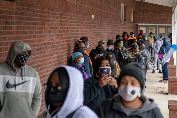 Fulton County residents wait in line at the C.T. Martin Natatorium to cast their ballots during early voting in December for 
Georgia's U.S. Senate runoffs in January. Under the state's new voting law, Senate Bill 202, the time for early voting in runoffs has been reduced because the time between a general election and runoff has been shortened from nine weeks to four weeks. (Alyssa Pointer / Alyssa.Pointer@ajc.com)