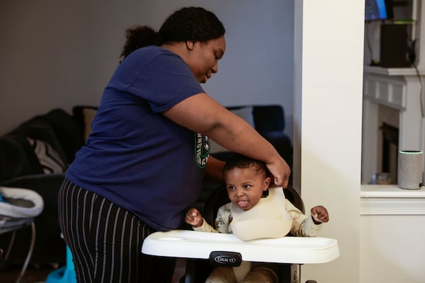 Shanyce Smith prepares her son Leonidas, 2, for dinner at her home in Douglasville on Thursday, Feb. 27, 2025. After receiving a scholarship for child care, Smith and her husband were able to save enough money to buy a new home and now have more free time to spend with their children instead of working multiple jobs to cover daycare. (Natrice Miller/ AJC)