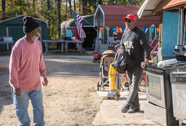 Larry Hinton (Right) talks with a customer at his booth at Sweeties Flea Market, located off U.S. 19/41 in Hampton. Steve Schaefer/steve.schaefer@ajc.com)