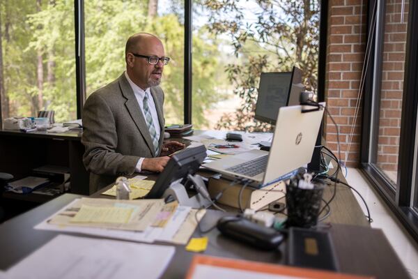 East Georgia State College President David Schecter works from his desk on campus. (Stephen B. Morton for The Atlanta Journal-Constitution)