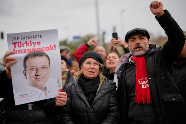 People chant slogans as they protest outside the Vatan Security Department, where Istanbul Mayor Ekrem Imamoglu is expected to be taken following his arrest in Istanbul, Turkey, on Wednesday, March 19, 2025. (AP Photo/Emrah Gurel)